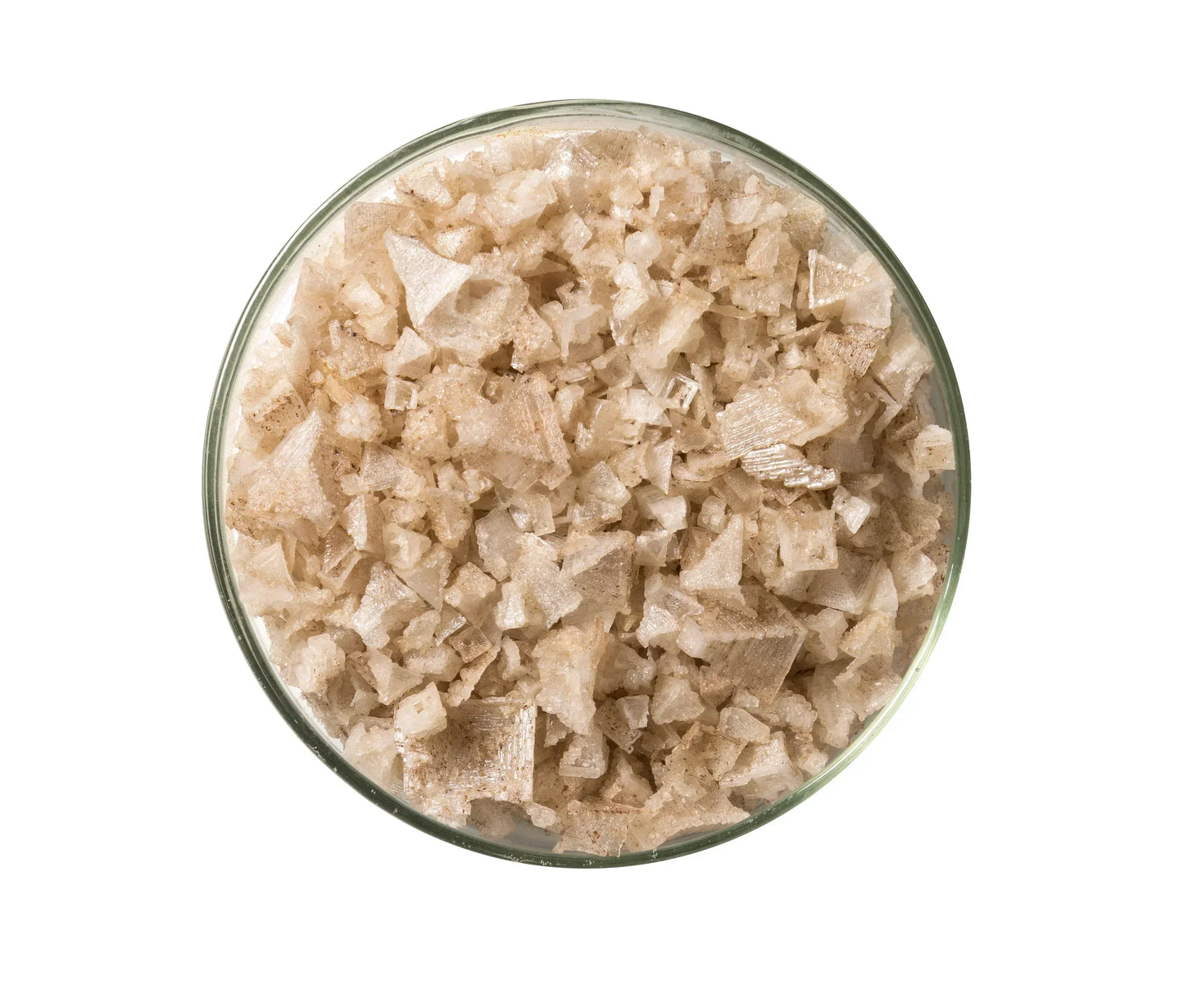 Glass bowl filled with natural smoked salt flakes, coarse texture, gourmet seasoning