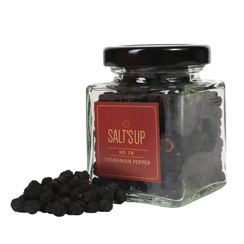 Glass jar of Salt's Up Tasmanian peppercorns with black peppercorns spilling out