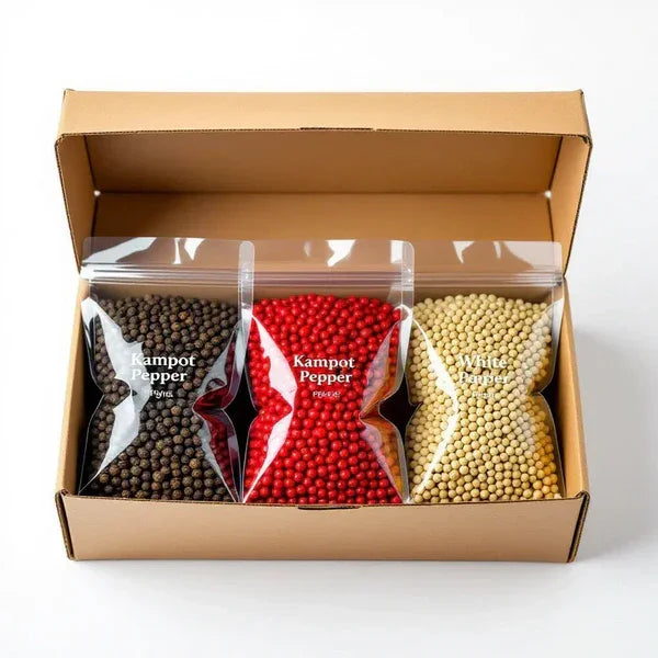 Gift box with three bags of Kampot peppercorns: black, red, and white varieties.