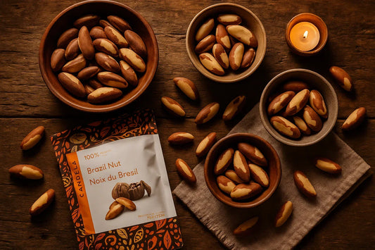 Brazil nuts in artisanal bowls on rustic wood with a candle and product packaging