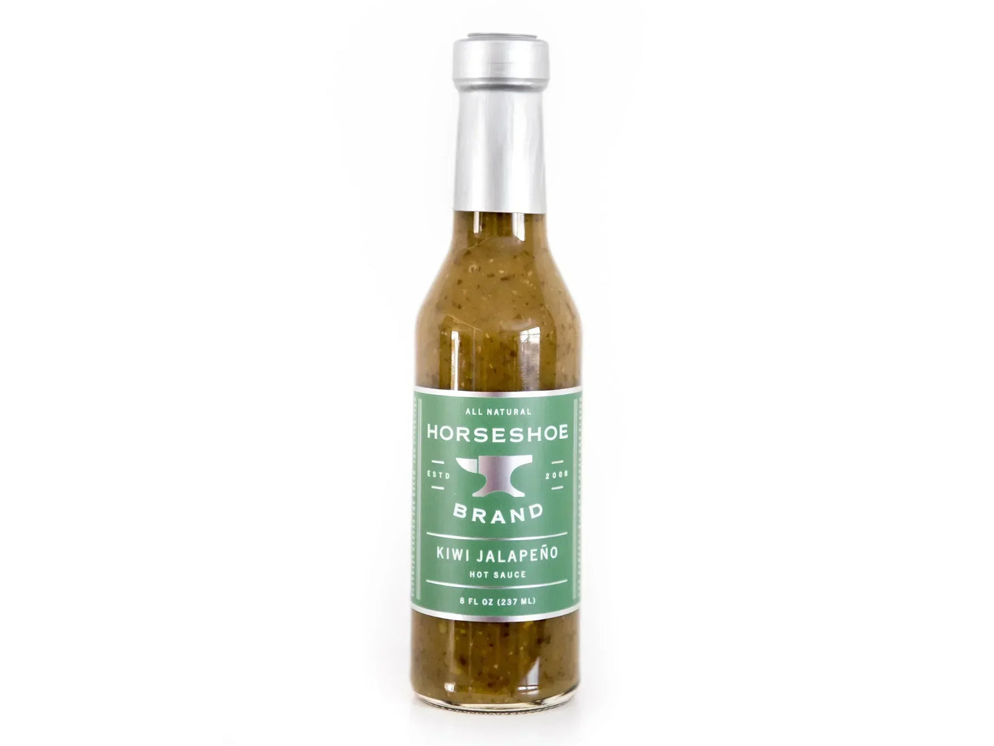 Glass bottle of kiwi jalapeño hot sauce with green label on white background