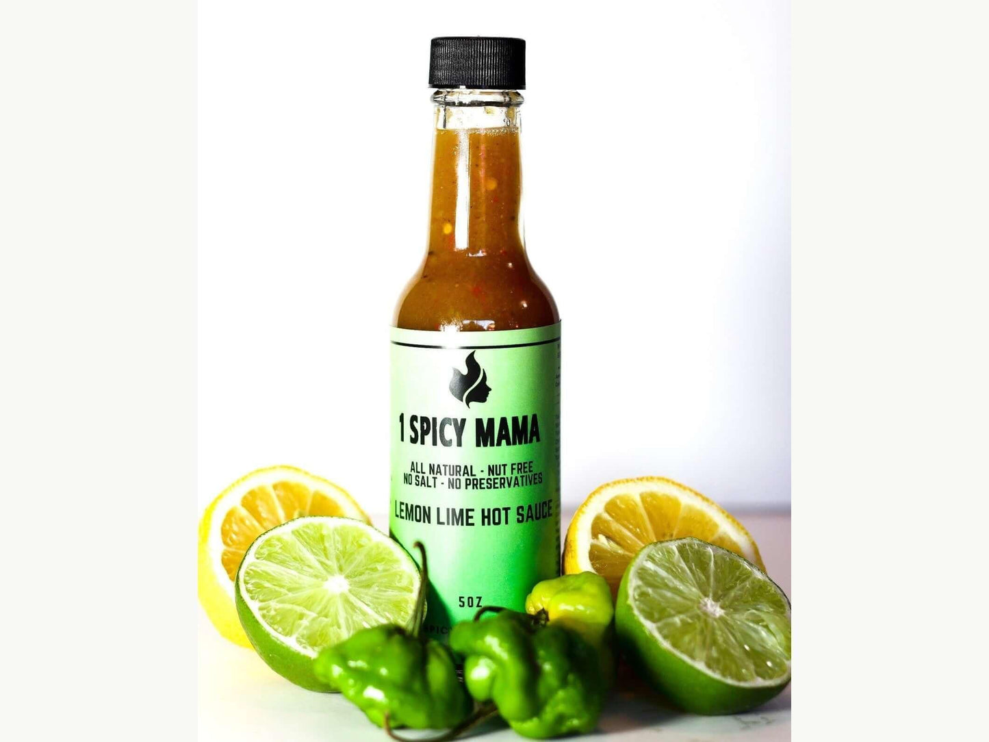 Lemon lime hot sauce bottle with sliced lemons, limes, and green peppers on white background