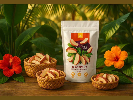 Freeze dried apple slices in baskets and a resealable pouch, surrounded by tropical flowers