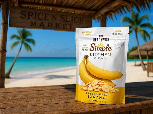 Freeze-dried banana snack pouch on a wooden table by a tropical beach with palm trees