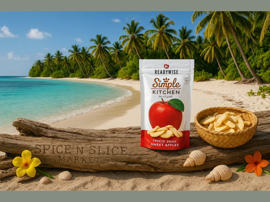 Freeze dried sweet apples in pouch and bowl on tropical beach with palm trees and ocean