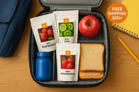 School lunchbox with dried fruit snacks, apple, sandwich, blue bottle, notebook and pencil