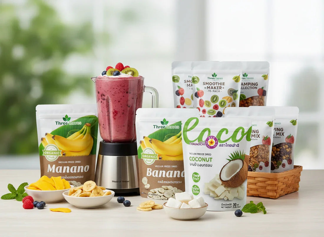 Mixed berry smoothie in blender surrounded by organic fruit snack packs and dried fruit bowls