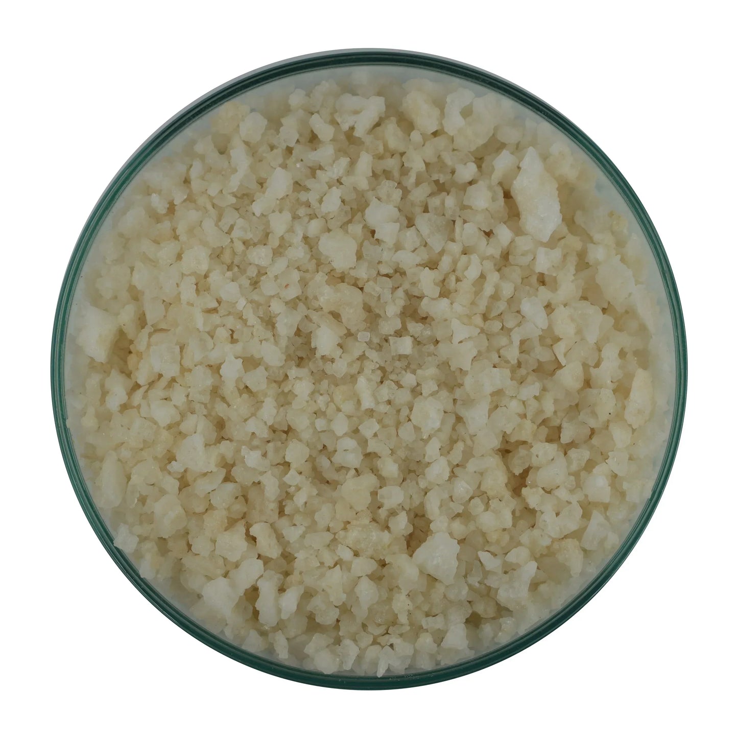 Coarse natural sea salt crystals in a glass bowl on white background