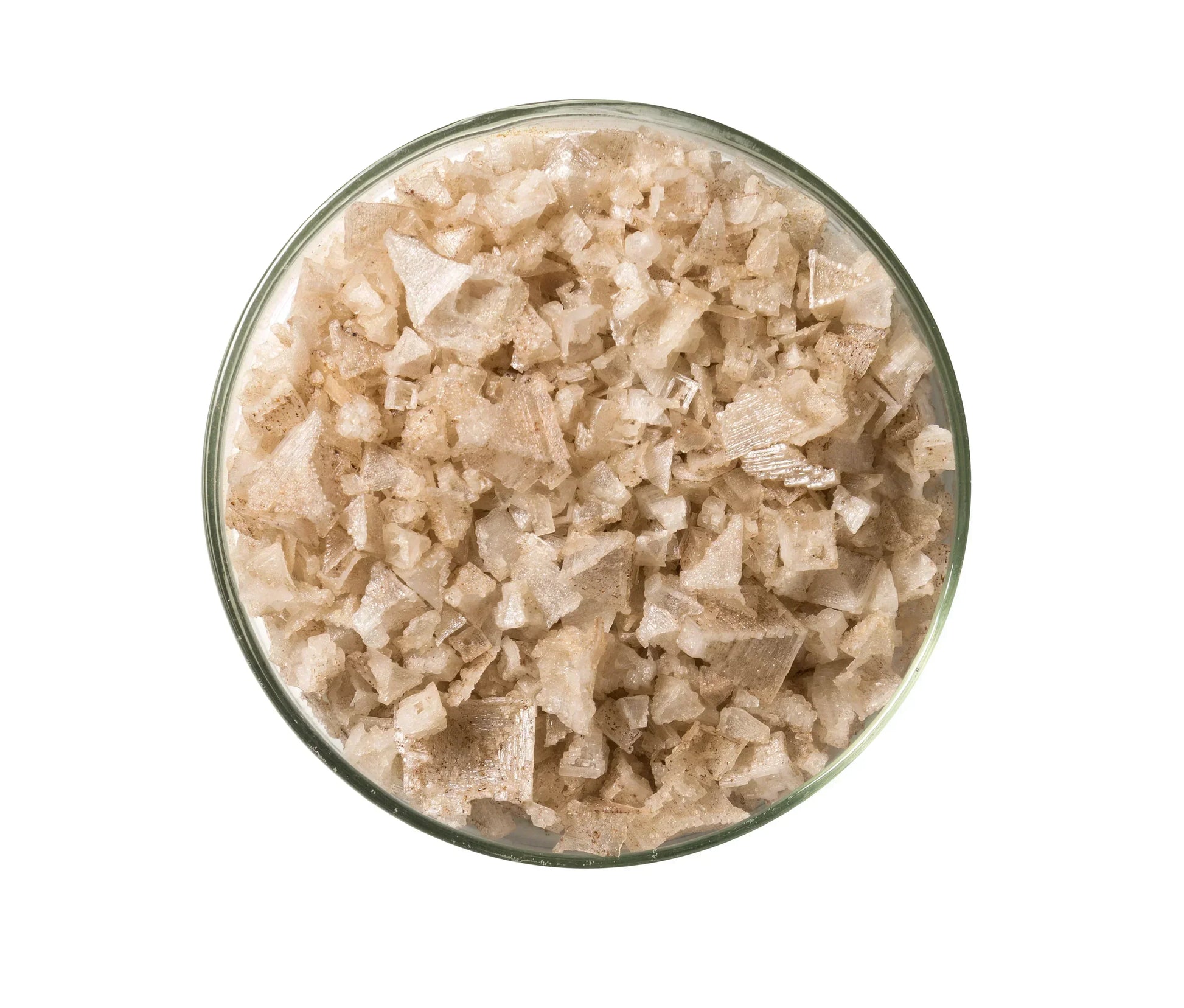 Glass bowl filled with natural smoked salt flakes, coarse texture, gourmet seasoning