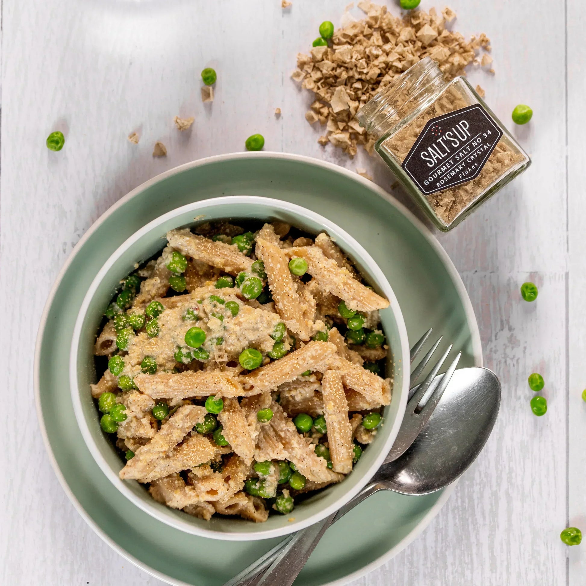 Whole wheat penne pasta with green peas, topped with SALT SUP rosemary crystal salt