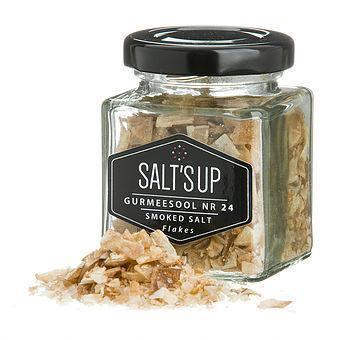 Glass jar of SALT’S UP smoked salt flakes with label, displayed on Spice n Slice Market.