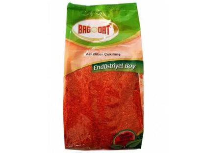 Bag of ground red chili pepper spice in clear packaging with green label