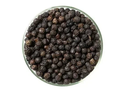 Glass bowl filled with whole black Kampot peppercorns on white background