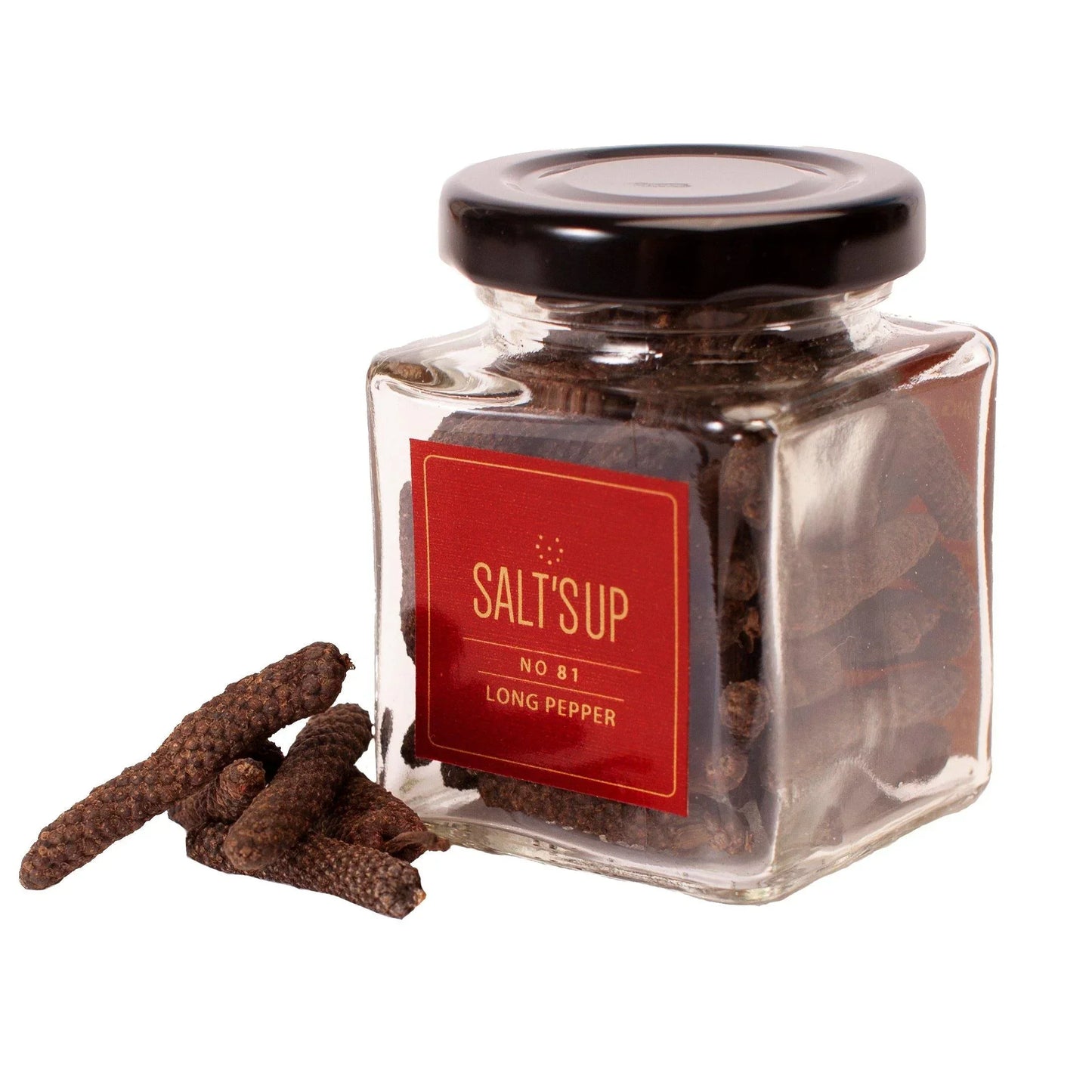 Glass jar of Salt'Up No 81 long pepper with black lid, some long pepper pods beside it, white background