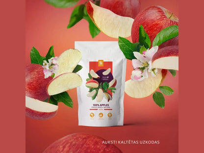 Freeze-dried apple slices in a white package with fresh apples, leaves, and apple blossoms on a red background.