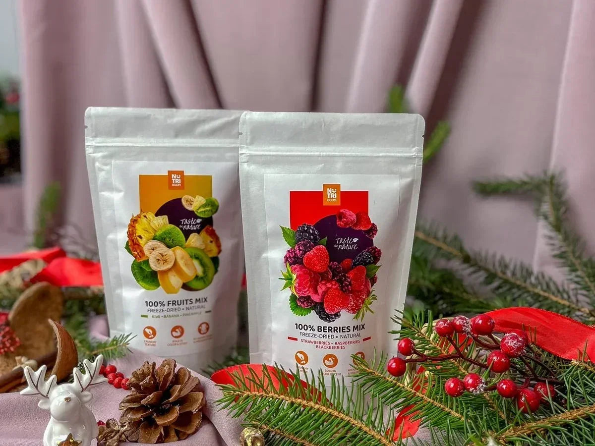 Freeze-dried fruit and berry snacks in resealable pouches with festive holiday decor