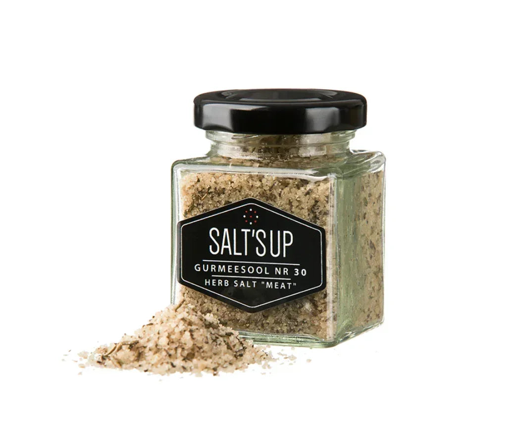 Glass jar of SALT'S UP gourmet herb salt for meat, with salt spilled, Spice n Slice Market.