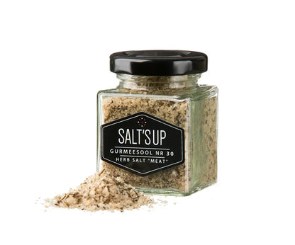 Glass jar of SALT'S UP gourmet herb salt for meat, with salt spilled, Spice n Slice Market.
