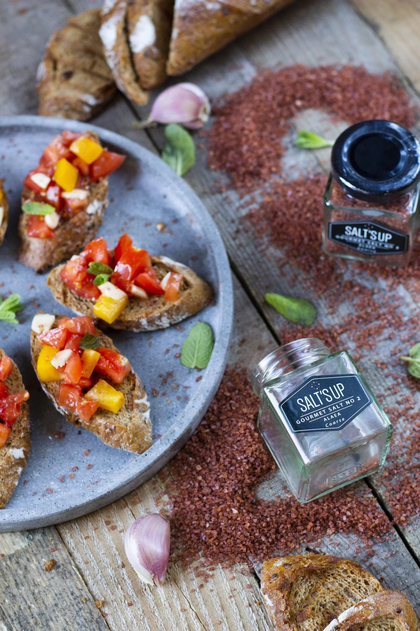 Bruschetta with tomatoes and garlic, coarse Alaea sea salt, rustic bread, Salt'sUp jar, Mint leaves