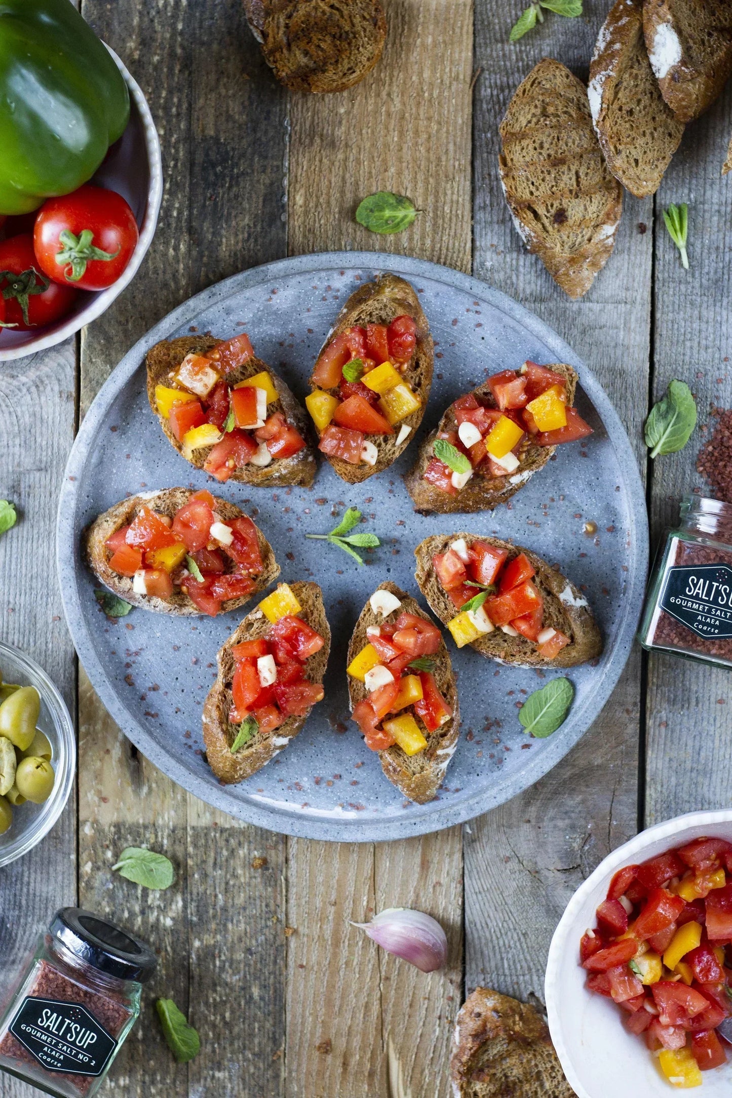 Artisan bruschetta with diced tomatoes, yellow peppers, and gourmet Alaea salt from Spice n Slice Market