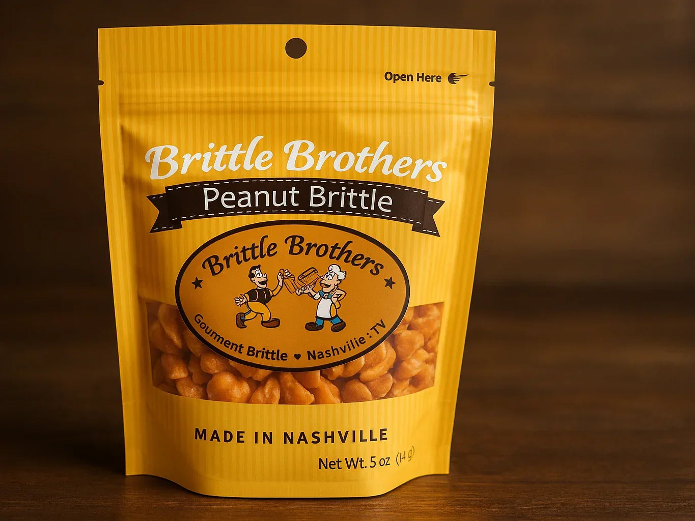 Yellow pouch of peanut brittle snack with clear window, labeled 'Brittle Brothers Peanut Brittle'.