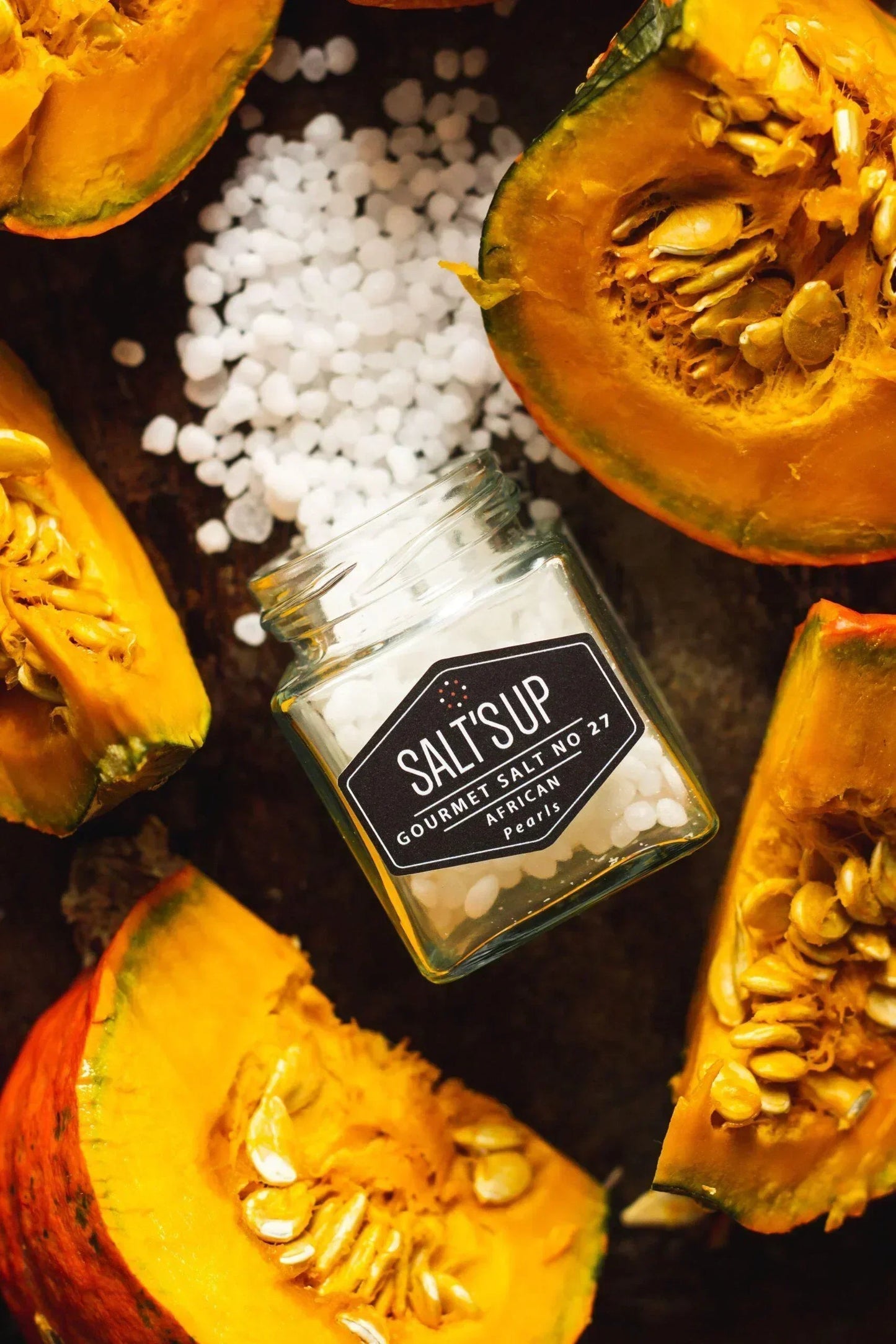SALT'SUP African pearl gourmet salt jar with fresh pumpkin slices on rustic background