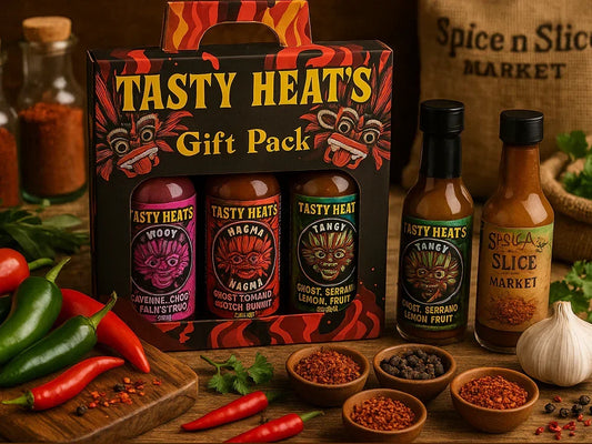 Tasty Heat's hot sauce gift pack with peppers, spices, and garlic on a rustic table