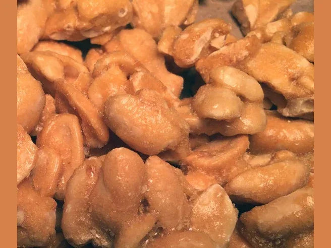 Close-up of golden roasted peanuts, crunchy snack food, healthy protein-rich nuts