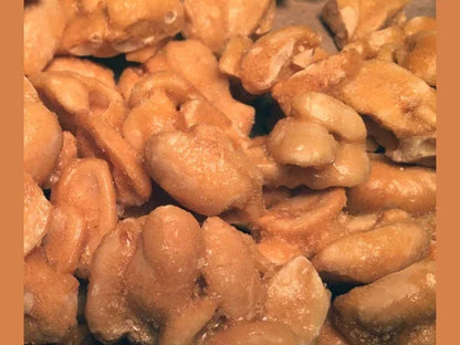 Close-up of golden roasted peanuts, crunchy snack food, healthy protein-rich nuts