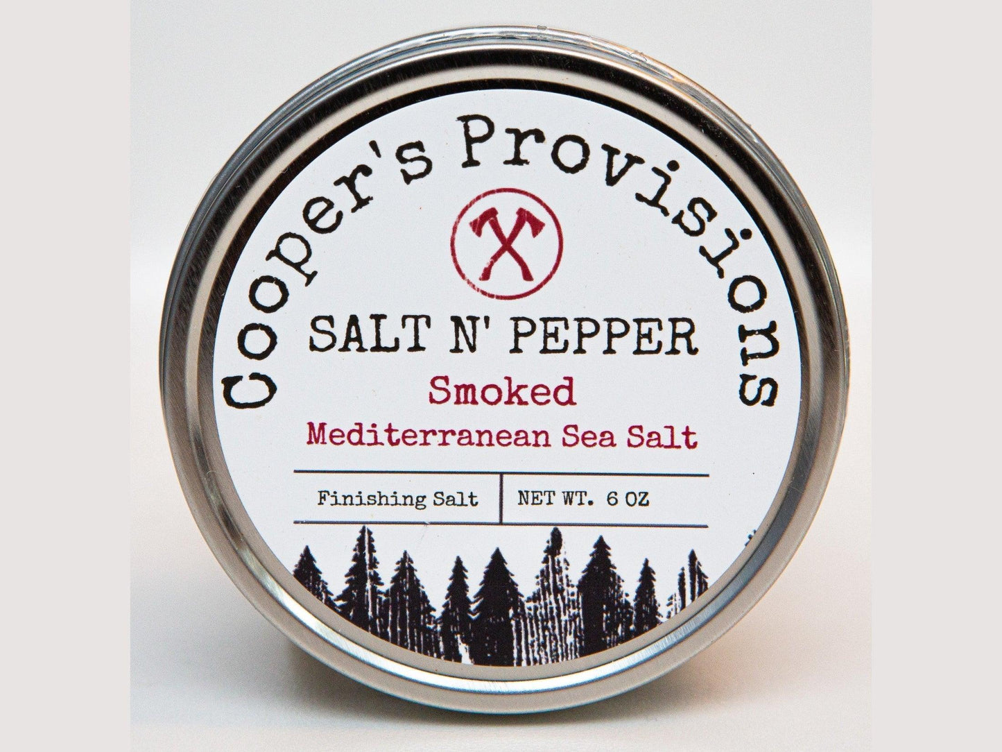 Round tin of smoked Mediterranean sea salt and pepper finishing salt, 6 oz, with forest design on label.