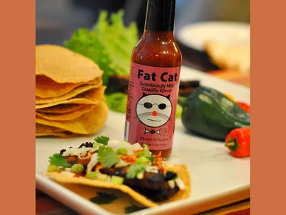Fat Cat guajillo ghost hot sauce with tortillas, tostada, and fresh peppers