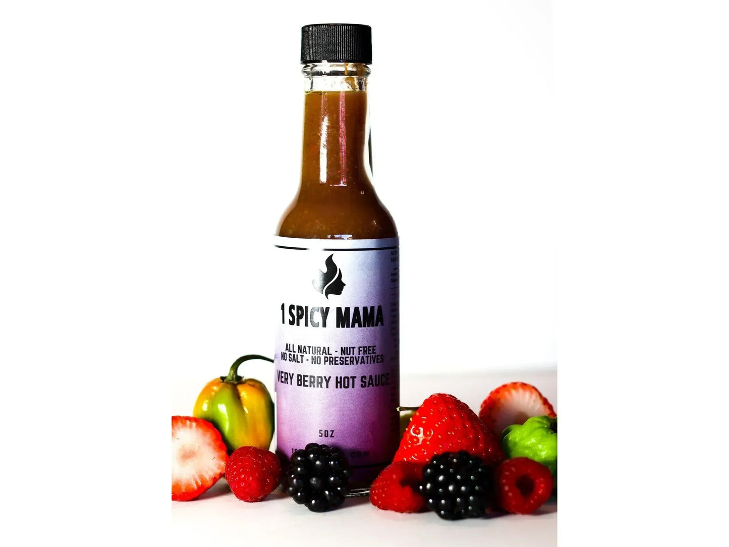 Berry hot sauce bottle with fresh strawberries, raspberries, blackberries, habanero pepper