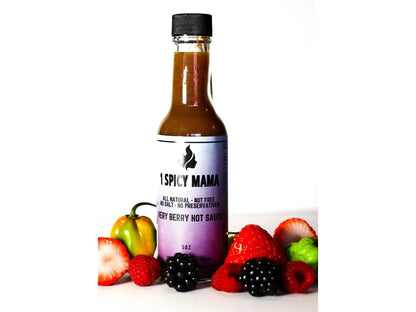 Berry hot sauce bottle with fresh strawberries, raspberries, blackberries, habanero pepper