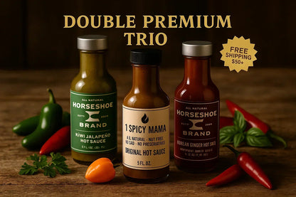 Trio of artisan hot sauces on rustic wood table with fresh peppers and herbs