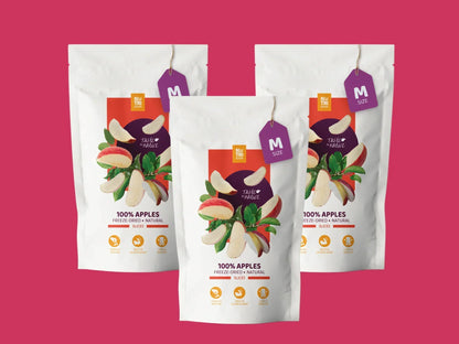 Three bags of freeze-dried apple slices, 100% natural, on a pink background