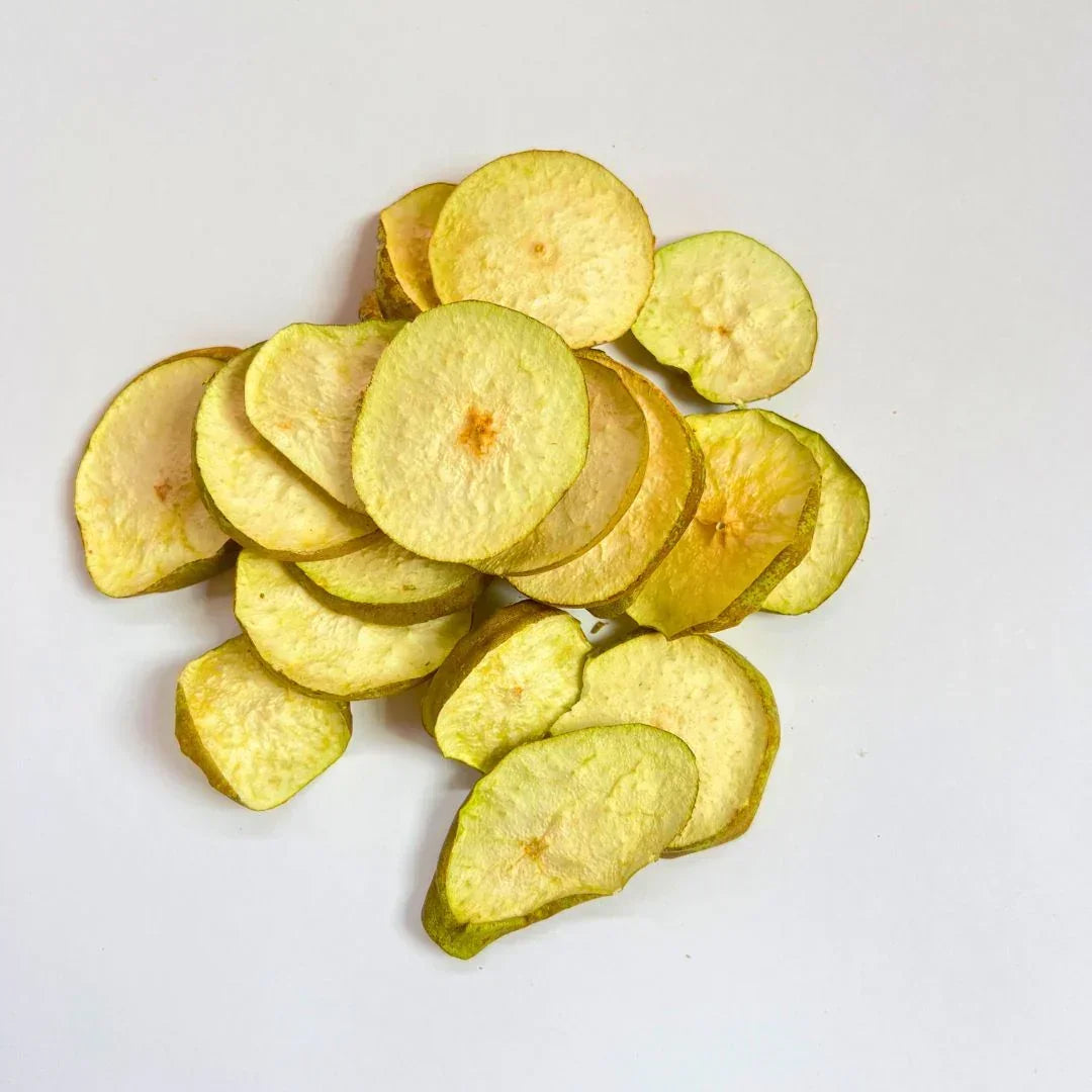 Freeze-dried pear slices healthy snack on white background, organic dried fruit