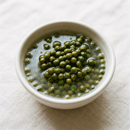 Green Kampot peppercorns in white-vinegar brine in a ceramic bowl