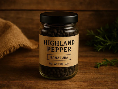 Jar of Highland Pepper Banasura whole black peppercorns on rustic wooden table