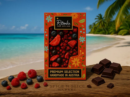 Box of premium handmade Austrian chocolate with dried berries on beach with chocolate pieces