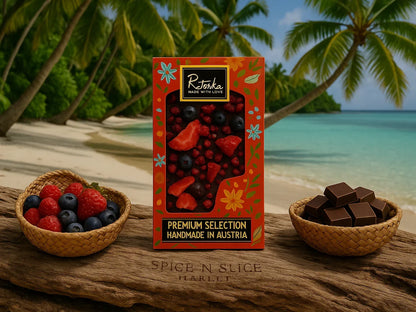 Premium selection handmade chocolate with dried berries on a tropical beach with fresh berries and chocolate pieces