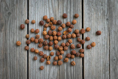 Whole dried Kampot peppercorns on rustic wooden surface