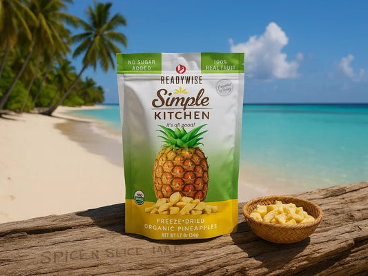 Freeze-dried organic pineapple snack pouch and pineapple pieces on beach with palm trees