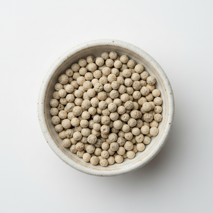 Kampot white pepper PGI peppercorns in ceramic bowl overhead shot