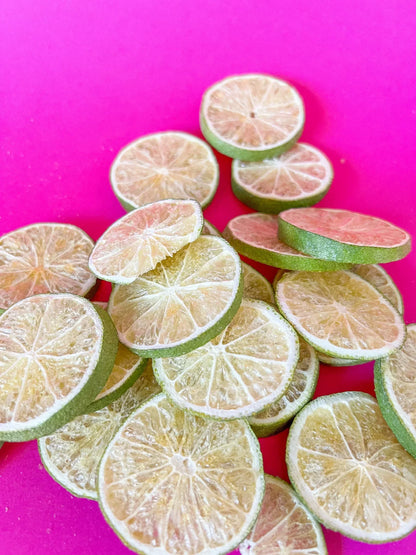 Dried lime slices on bright pink background, organic dried fruit from Spice n Slice Market