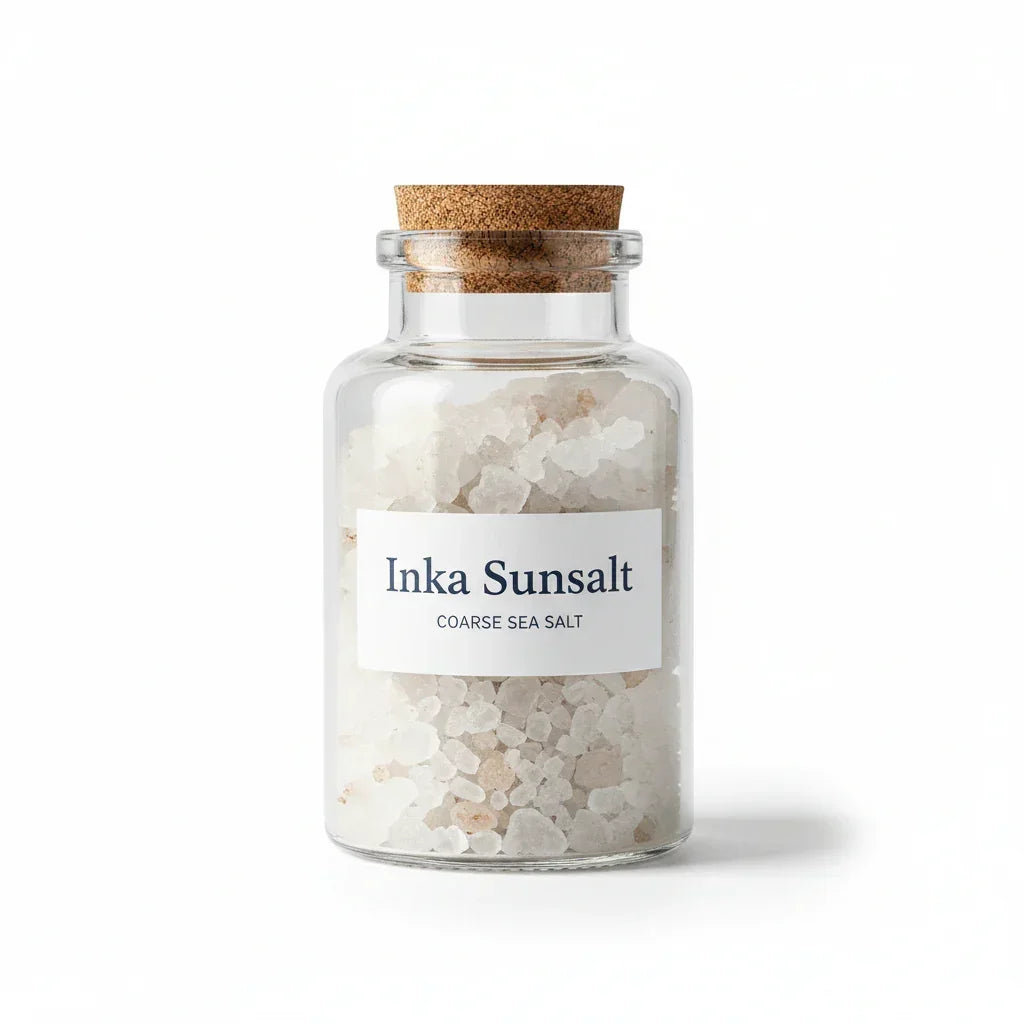 Glass jar with coarse Inka Sunsalt sea salt and cork lid on white background