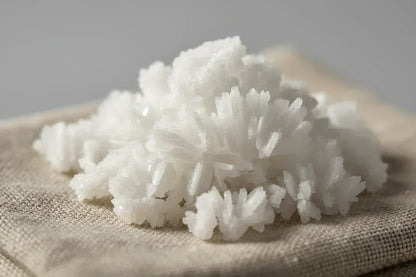 Close-up of Kampot fleur de sel crystals on a textured beige cloth