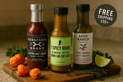 Trio of gourmet hot sauces on a kitchen board with habanero peppers, herbs, and lime