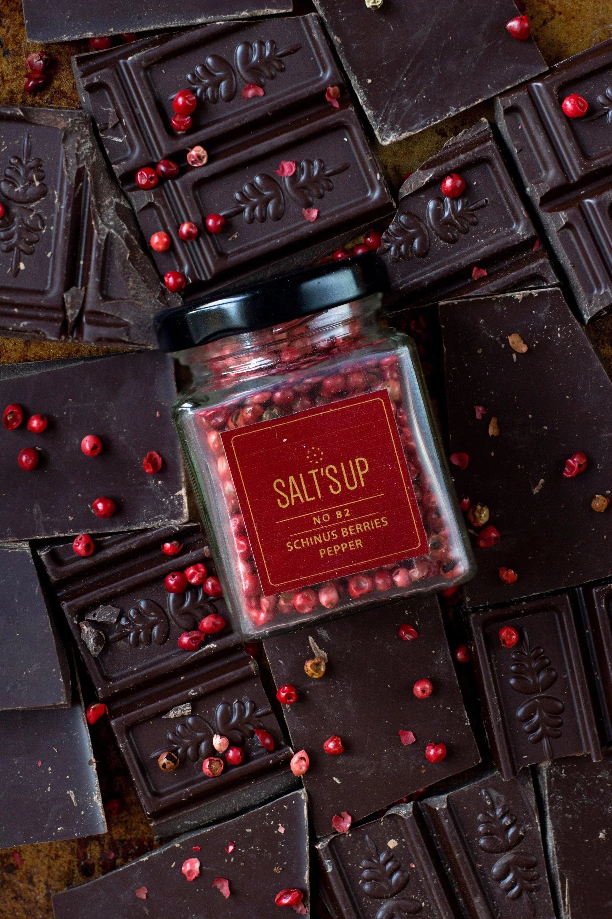 Schinus berries pepper jar on artisan dark chocolate bars with spice n slice market theme