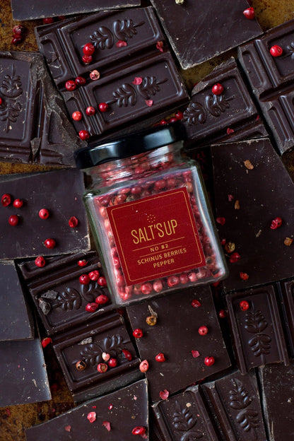 Schinus berries pepper jar on artisan dark chocolate bars with spice n slice market theme