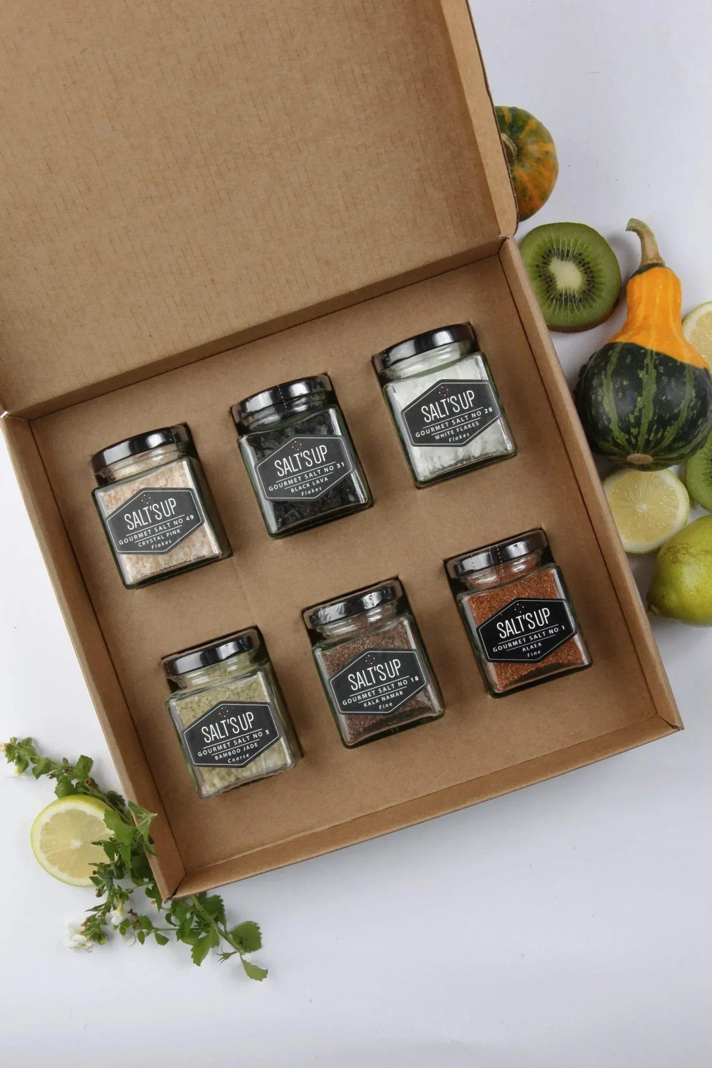 Spice n Slice Market gourmet salt gift set with six jars, fruits and herbs displayed